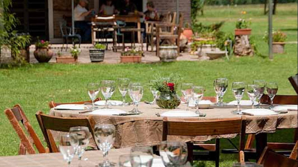 Argentina, Buenos Aires, San Antonio de Areco. Estancia El Ombu de Areco. Outdoor tables set up for tourist ranch lunch. ( Cindy Miller Hopkins / DanitaDelimont.com)